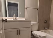 Thumbnail 38 of 48 - a bathroom with a toilet and a sink and a mirror