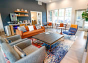 Thumbnail 46 of 49 - A living room with a grey sofa and a coffee table.