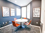 Thumbnail 47 of 49 - A room with a round table and chairs.