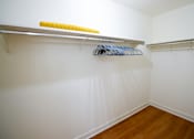 Thumbnail 49 of 49 - A white closet with a yellow and blue hanger.