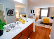 Thumbnail 39 of 49 - A bathroom with a white counter top and a white sink.
