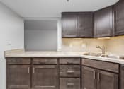 Thumbnail 6 of 49 - a kitchen with wooden cabinets and a sink