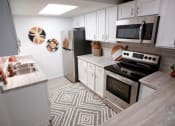 Thumbnail 4 of 36 - a kitchen with stainless steel appliances and white cabinets