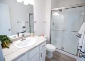 Thumbnail 11 of 36 - a bathroom with a sink toilet and a shower