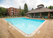 Thumbnail 30 of 49 - a pool with a brick building in the background