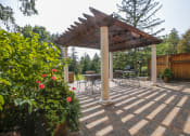 Thumbnail 33 of 49 - a patio with a pergola and a table and chairs