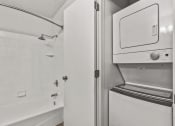 Thumbnail 15 of 49 - a laundry room with a washer and dryer