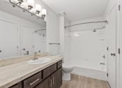 Thumbnail 13 of 49 - a bathroom with a toilet sink and shower
