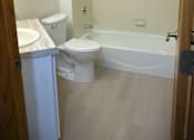 Thumbnail 21 of 49 - A white toilet and sink in a small bathroom.