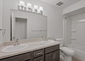 Thumbnail 14 of 25 - a bathroom with two sinks and a shower double vanity and a toilet