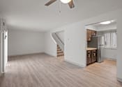 Thumbnail 6 of 25 - the living room and kitchen of an apartment with wood flooring
