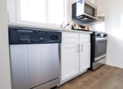 Thumbnail 15 of 18 - a kitchen with a dishwasher and a stove and a microwave