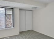 Thumbnail 15 of 36 - A room with a window and a sliding door.