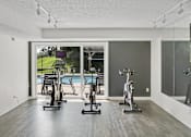 Thumbnail 5 of 30 - A room with a pool table and exercise bikes.
