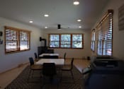 Thumbnail 22 of 27 - A room with a table, chairs, and a printer.