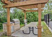 Thumbnail 48 of 67 - A wooden pergola with a picnic table underneath it.