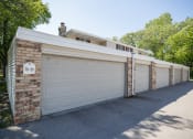 Thumbnail 29 of 36 - a garage with a white door and a man standing on top of it