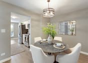 Thumbnail 33 of 41 - A modern dining room with a round table set for two.