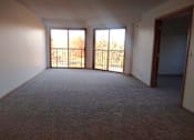 Thumbnail 41 of 49 - A room with carpeted floor and two sliding glass doors.