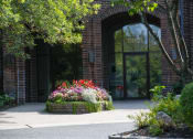 Thumbnail 1 of 49 - the front of a building with a flower garden in front of it