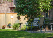 Thumbnail 11 of 49 - a yard with lawn chairs and a tree and a fence