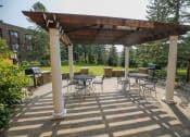 Thumbnail 32 of 49 - a covered patio with tables and chairs and a pergola