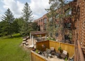 Thumbnail 10 of 49 - a backyard with a patio and a brick building