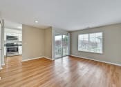 Thumbnail 29 of 36 - an empty living room with wood flooring and a sliding glass door