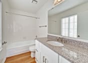 Thumbnail 32 of 36 - a bathroom with a sink and a toilet and a bath tub