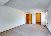 Thumbnail 28 of 36 - an empty living room with white walls and carpet