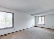 Thumbnail 27 of 36 - an empty living room with a large window and white walls