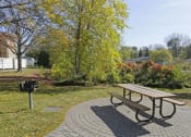 Thumbnail 31 of 36 - a picnic table and bench in a park