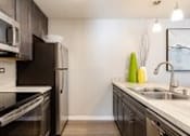 Thumbnail 10 of 40 - A kitchen with a sink and refrigerator