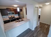 Thumbnail 13 of 67 - a view of a kitchen and living room in an apartment