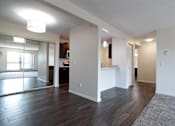 Thumbnail 14 of 67 - an empty living room and kitchen with wood floors and white walls