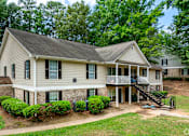 Thumbnail 8 of 19 - A house with a front yard and a deck.