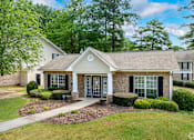 Thumbnail 1 of 19 - A house with a front yard and a tree.