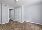 Thumbnail 5 of 19 - A room with a carpeted floor and a white door.