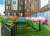 Thumbnail 23 of 29 - A mural of a dog and a cat painted on a wall.