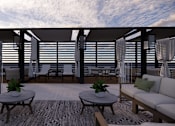 Thumbnail 11 of 15 - A modern outdoor living space with a wooden floor, white furniture, and a striped rug.