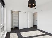Thumbnail 32 of 32 - A white room with a black ceiling light and a grey carpet.