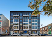 Thumbnail 1 of 32 - A multi-story building with a Putnam Bank branch in front.