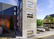 Thumbnail 2 of 36 - A modern building with a grey facade and a large window on the top floor.