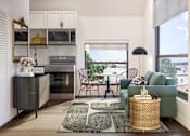 Thumbnail 4 of 36 - A modern kitchen with a green couch and a dining table.