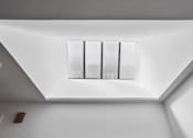 Thumbnail 33 of 36 - A window with a white frame is in the corner of a room.