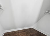 Thumbnail 35 of 36 - A room with white walls and wooden flooring.