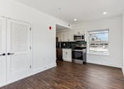 Thumbnail 11 of 36 - A kitchen with white cabinets and a black stove top oven.