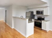 Thumbnail 3 of 13 - a kitchen with white cabinets and stainless steel appliances