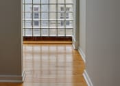 Thumbnail 8 of 13 - a living room with a large window and wooden floors