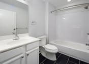 Thumbnail 11 of 13 - a bathroom with a sink toilet and a tub